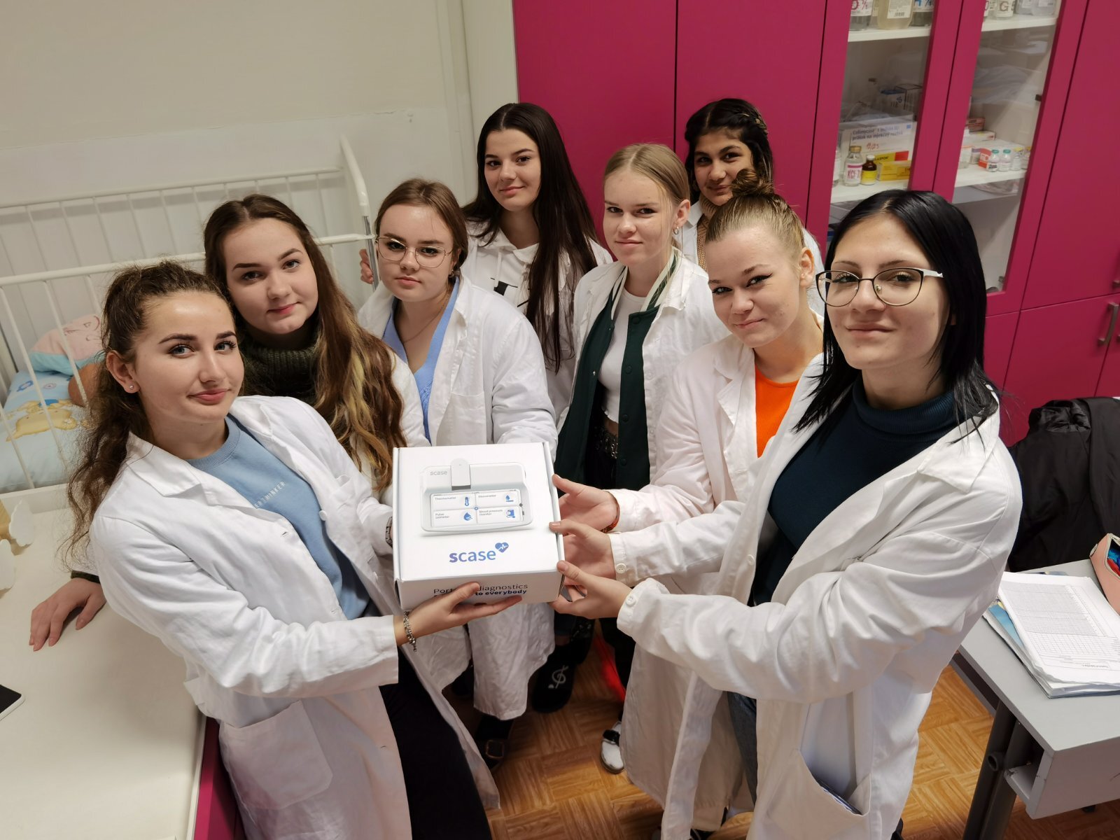 Medical students holding Scase box
